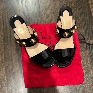 Christian louboutin black heels with gold accent..